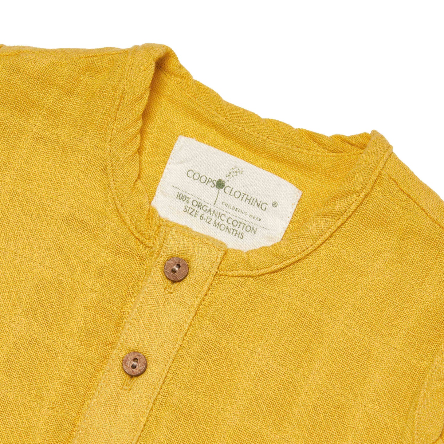 Yellow overall with a Coops Clothing label and coconut shell buttons on a white background