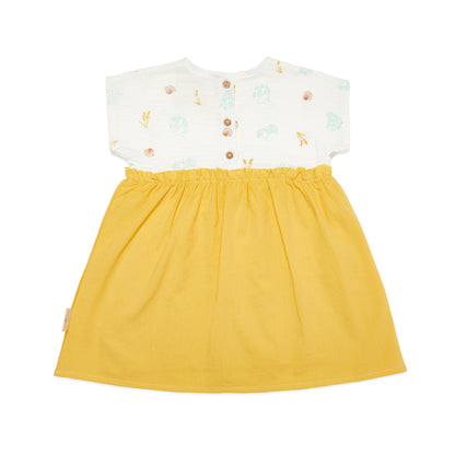Yellow dress with a white top featuring floral patterns  and coconut shell buttons on a white background