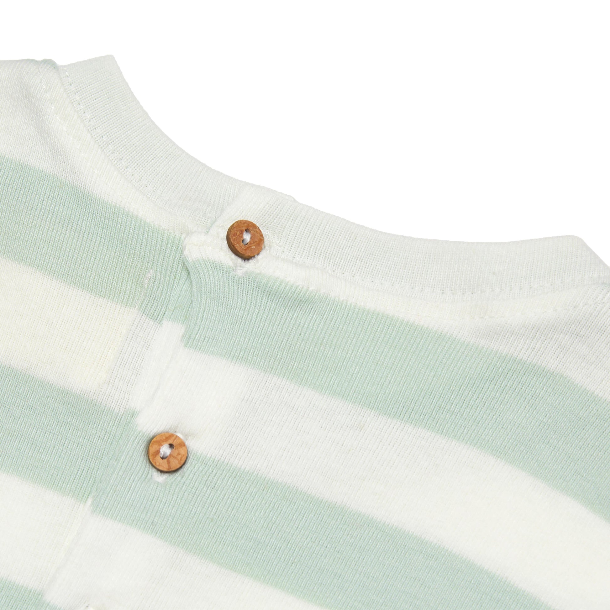 Close-up of a baby outfit with green and white stripes and coconut shell button's buttons on a white background