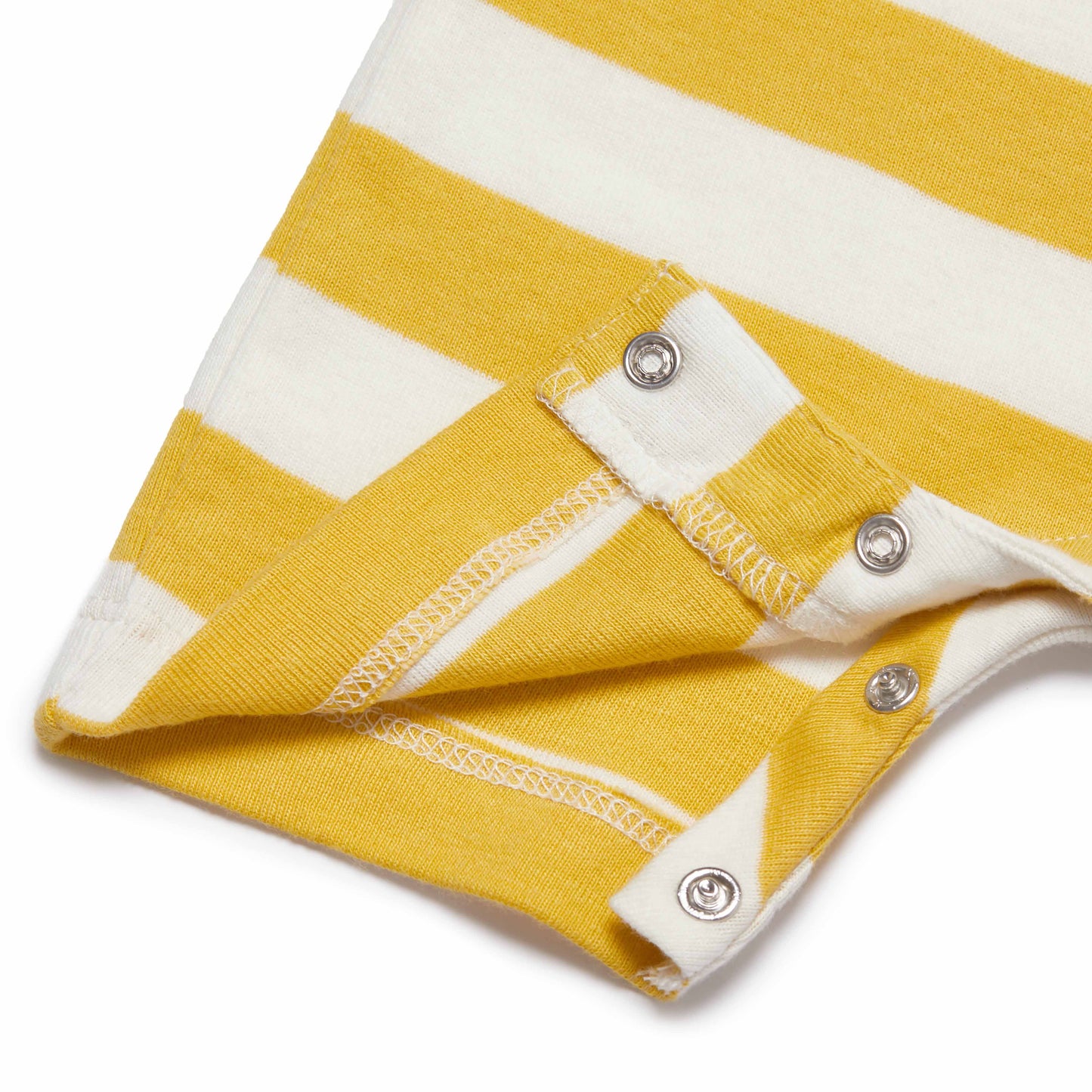 Close-up of a yellow and white striped fabric with buttons on a white background