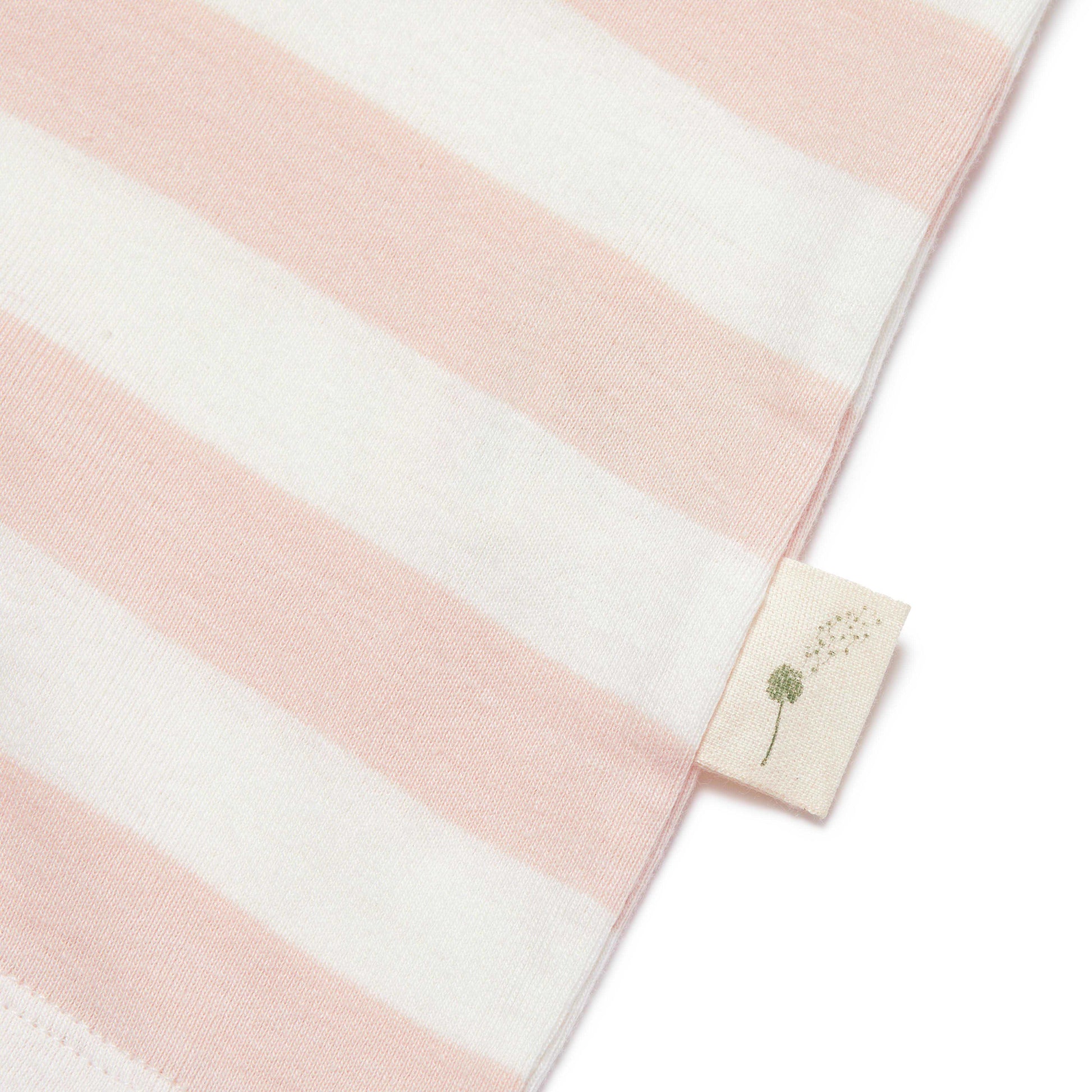 Pink and white striped fabric with a small tag featuring a dandelion design on a white background