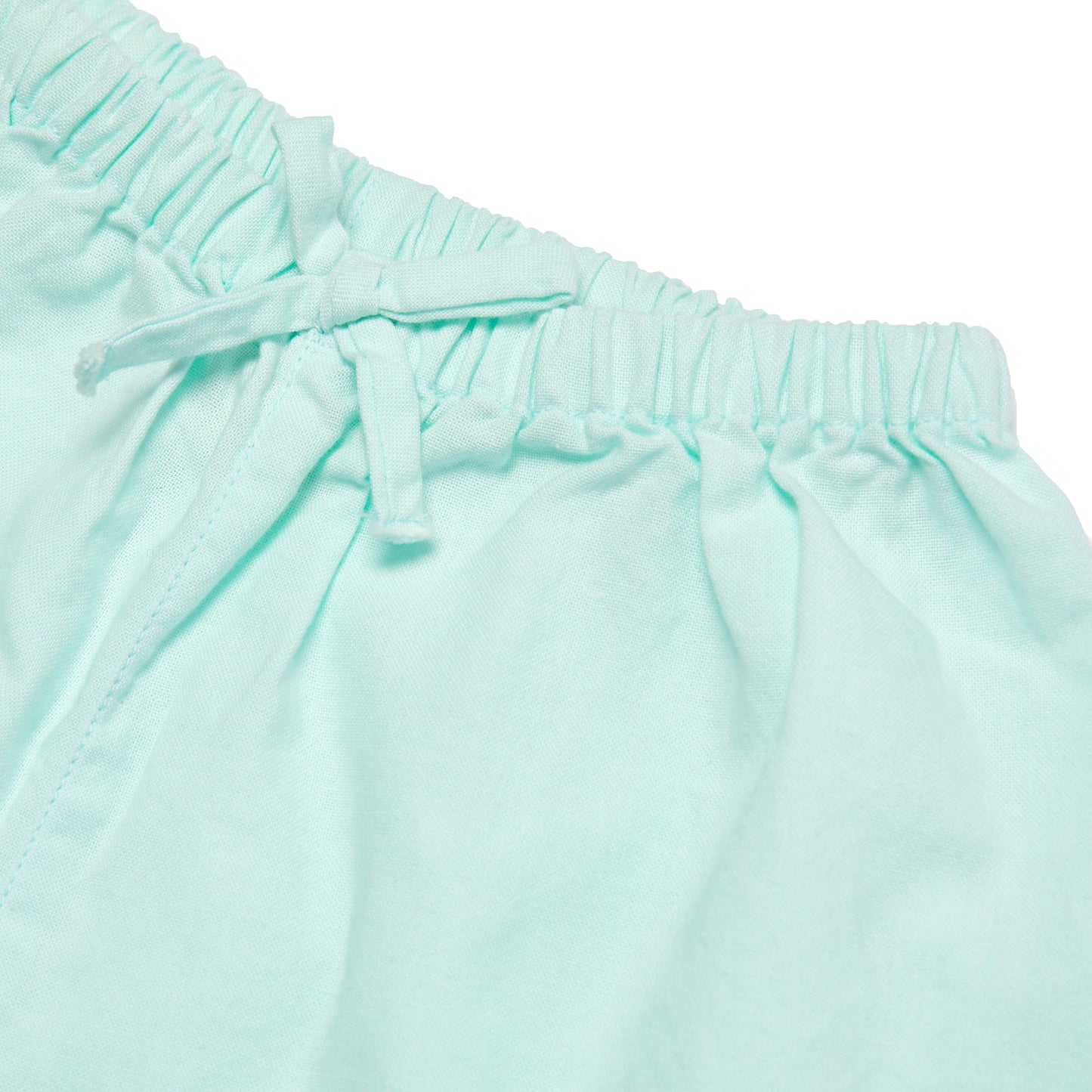 Close-up of light blue pants with an elastic waistband on a white background