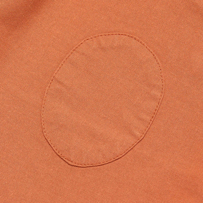 Close-up of a orange fabric pocket with stitching detail